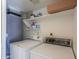 Laundry room features a washer, dryer, and shelving for convenient storage at 4843 W Del Rio St, Chandler, AZ 85226