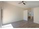 Spacious main bedroom with vinyl floors, ceiling fan, and ensuite bathroom access at 4843 W Del Rio St, Chandler, AZ 85226