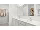 Bright bathroom with double vanity sinks, white cabinets, and a large mirror at 5008 S 105Th Ln, Tolleson, AZ 85353