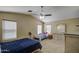 Well-lit bedroom featuring carpet, ceiling fan, and two beds with dressers for ample storage at 5071 W Warren Dr, Casa Grande, AZ 85194