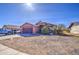 Single-story home with low-maintenance desert landscaping and an attached two-car garage at 5071 W Warren Dr, Casa Grande, AZ 85194