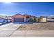 Single-story home with desert landscaping, an attached two-car garage, and a covered entryway at 5071 W Warren Dr, Casa Grande, AZ 85194