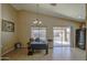 Bright home office area featuring tile floors, a modern chandelier, and sliding glass doors at 5071 W Warren Dr, Casa Grande, AZ 85194