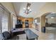 Bright kitchen with wooden cabinets, black appliances, tile flooring, and an adjacent workstation at 5071 W Warren Dr, Casa Grande, AZ 85194