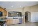 Well-lit kitchen with light oak cabinets, stainless steel dishwasher, and tile flooring at 5071 W Warren Dr, Casa Grande, AZ 85194