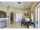 Bright office featuring tile flooring, built in bar, hanging light fixture, and white closet doors at 5071 W Warren Dr, Casa Grande, AZ 85194