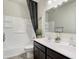 Bright bathroom featuring a dual sink vanity with dark wood cabinets, white countertops, and a shower-tub combo at 5106 E Umber Rd, San Tan Valley, AZ 85143