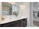 Bright bathroom featuring a dual sink vanity with dark wood cabinets and a large mirror with modern lighting at 5106 E Umber Rd, San Tan Valley, AZ 85143