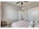 Neutral bedroom featuring a ceiling fan, double closets, soft carpet, and natural light, offering a cozy retreat at 5106 E Umber Rd, San Tan Valley, AZ 85143