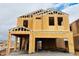 New construction shows the exterior framing of a two-story home with a garage, under a cloudy sky at 5106 E Umber Rd, San Tan Valley, AZ 85143