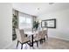 An elegant dining room with a chandelier, a window with blinds, and neutral-toned decor at 5106 E Umber Rd, San Tan Valley, AZ 85143