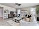 Bright living room with comfortable seating, decorative shelving, and a ceiling fan at 5106 E Umber Rd, San Tan Valley, AZ 85143