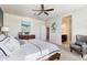 Comfortable main bedroom featuring a ceiling fan, a wooden dresser, stylish décor, and a gray armchair at 5106 E Umber Rd, San Tan Valley, AZ 85143