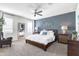 Cozy main bedroom features a king-size bed, carpeted floors, and a full-length mirror at 5106 E Umber Rd, San Tan Valley, AZ 85143