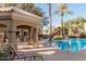 Outdoor covered seating area by community pool featuring an outdoor grill and tables at 5335 E Shea Blvd # 2126, Scottsdale, AZ 85254