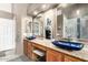 Bathroom with vessel sinks, granite countertops, and wooden cabinets at 5462 W Geronimo St, Chandler, AZ 85226