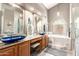 The bathroom features vessel sinks, wood cabinetry, and a separate tub and shower at 5462 W Geronimo St, Chandler, AZ 85226