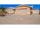 Tan home with a well-manicured yard, a large driveway, and an attached garage at 5462 W Geronimo St, Chandler, AZ 85226