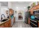 An open kitchen featuring wood cabinets, stainless steel appliances, and granite countertops at 5462 W Geronimo St, Chandler, AZ 85226