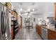 Well-lit kitchen featuring stainless steel appliances, tile flooring, and granite countertops at 5462 W Geronimo St, Chandler, AZ 85226