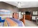 A well-appointed main bedroom with a ceiling fan, dark walls and carpet flooring at 5462 W Geronimo St, Chandler, AZ 85226