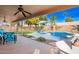 Inviting backyard with a sparkling pool, covered patio, and a well-manicured lawn, perfect for outdoor entertaining at 5462 W Geronimo St, Chandler, AZ 85226