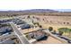 Beautiful aerial view of a beige home with desert landscaping, a tile roof, and a peek at the community golf course at 5550 N Luna Dr, Eloy, AZ 85131