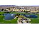 An aerial view shows the pond and landscaping along the golf course in the Robson Ranch community at 5550 N Luna Dr, Eloy, AZ 85131