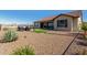 Expansive backyard with desert landscaping, turf grass, and outdoor dining area at 5550 N Luna Dr, Eloy, AZ 85131