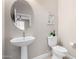 Contemporary powder room featuring pedestal sink, toilet, neutral paint and modern decor at 5550 N Luna Dr, Eloy, AZ 85131