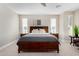 A primary bedroom featuring a dark wood bed frame, neutral tones, and natural light from the windows at 5550 N Luna Dr, Eloy, AZ 85131