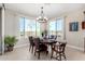 This dining room features a round table, chandelier, and natural light with views of the golf course at 5550 N Luna Dr, Eloy, AZ 85131