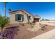 Charming home showcasing an attractive desert landscape and two-car garage, creating inviting curb appeal at 5550 N Luna Dr, Eloy, AZ 85131