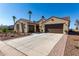 Well-maintained home features a wide driveway and a three-car garage, perfect for car enthusiasts at 5550 N Luna Dr, Eloy, AZ 85131