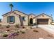 Desert landscaped front yard with colorful flowers, cacti and charming two-car garage enhance this lovely home at 5550 N Luna Dr, Eloy, AZ 85131