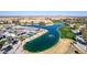 An aerial view of the golf course with ponds, green grass, desert landscape, and modern homes at 5550 N Luna Dr, Eloy, AZ 85131