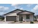 Beautiful single-story home with neutral stucco, dark gray trim, and a two-car garage at 5583 S 240Th Ln, Buckeye, AZ 85326