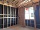 Interior framing of a new home showcases a window, electrical wiring, and wall studs at 5583 S 240Th Ln, Buckeye, AZ 85326