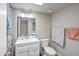 Cozy bathroom with white vanity, toilet, and shower with patterned curtain at 620 S Allred Dr, Tempe, AZ 85288