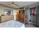 Bedroom featuring matching dressers, ceiling fan, closet, and decorative bedding at 620 S Allred Dr, Tempe, AZ 85288