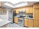 Sunlit kitchen featuring stainless appliances, light wood cabinetry, and mosaic backsplash at 620 S Allred Dr, Tempe, AZ 85288