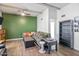 Bright living room featuring beam ceilings, green accent wall, and laminate flooring at 620 S Allred Dr, Tempe, AZ 85288