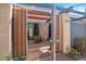 Private entry patio with desert landscaping, metal pergola and a security gate at 620 S Allred Dr, Tempe, AZ 85288