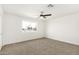 Bright bedroom featuring neutral carpet and a large window at 6655 E Rustic Dr, Mesa, AZ 85215