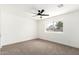 Bright bedroom featuring neutral carpet and a large window at 6655 E Rustic Dr, Mesa, AZ 85215