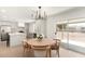 Bright dining area adjacent to the kitchen, featuring a modern chandelier and sliding doors to the yard at 6655 E Rustic Dr, Mesa, AZ 85215