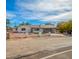 Charming home featuring a white brick exterior, carport, and freshly landscaped front yard at 6655 E Rustic Dr, Mesa, AZ 85215