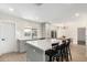 Modern kitchen featuring gray cabinetry, a white tile backsplash, and a view into the dining area at 6655 E Rustic Dr, Mesa, AZ 85215