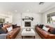 Spacious living room showcasing a brick fireplace, hardwood floors, and contemporary decor at 6655 E Rustic Dr, Mesa, AZ 85215