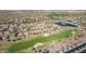 Expansive aerial shot featuring community golf course, pond, and residential homes at 6656 W Springfield Way, Florence, AZ 85132